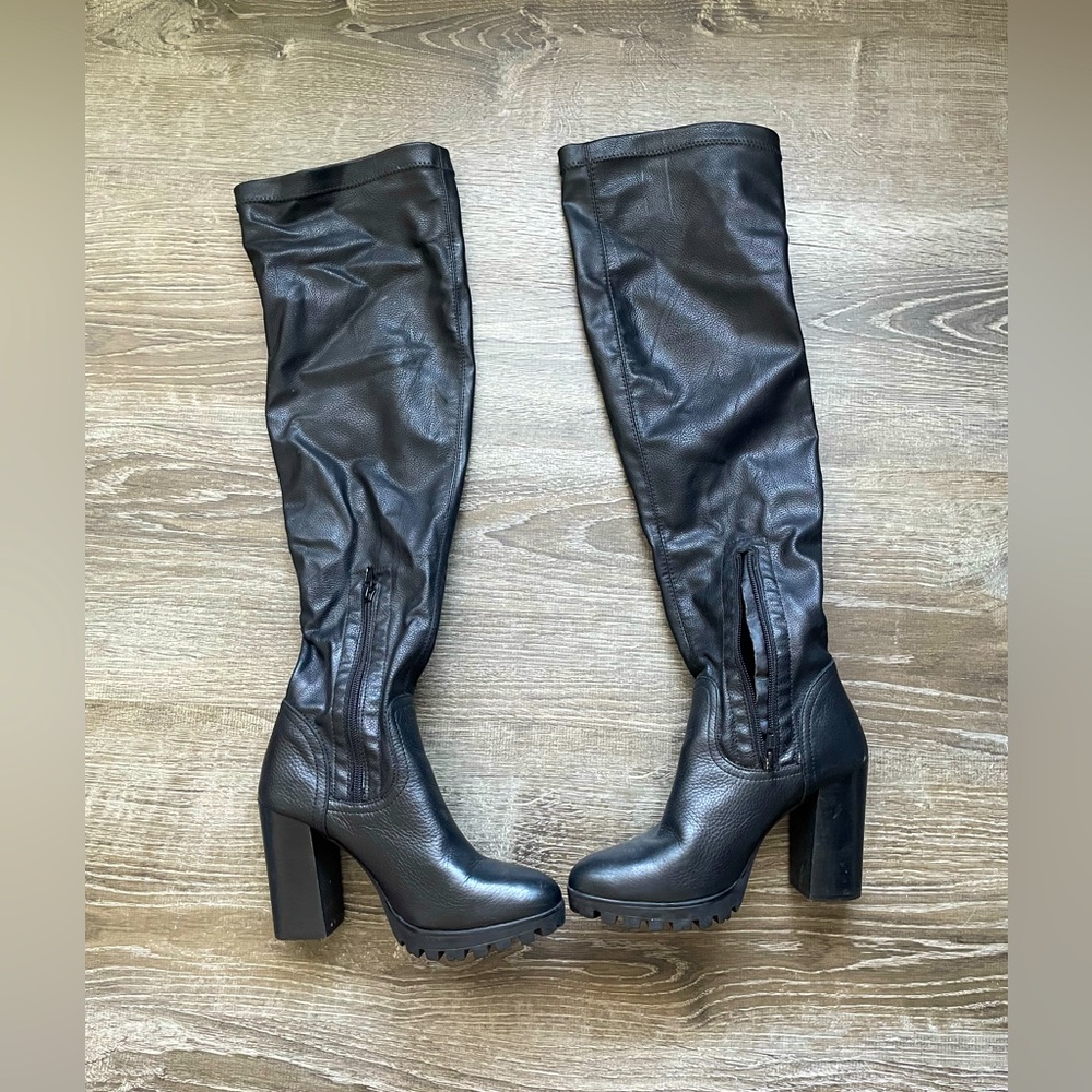 Black leather high knee boots.
